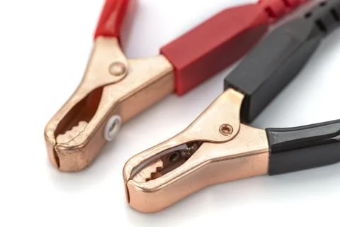 A close up of two alligator clips with red and black handles on white Photos
