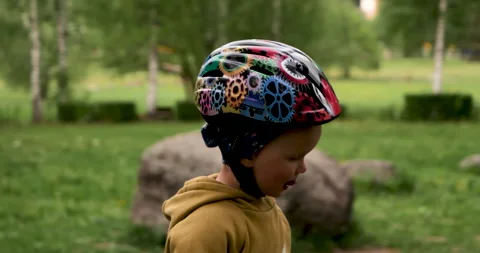 Close-up of a two and a half year old boy with a helmet on his head. Stock Footage 243414599