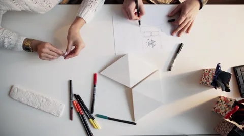 Close Up Of two Architects Discussing Plan Together At Desk With Blueprints Stock Footage 56949574