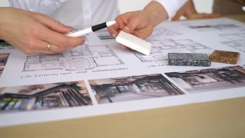 Close Up Of two Architects Discussing Plan Together At Desk With Blueprints Stock Footage 88640063