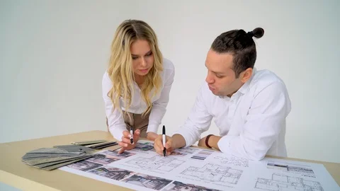 Close Up Of two Architects Discussing Plan Together At Desk With Blueprints Video stock 88641624