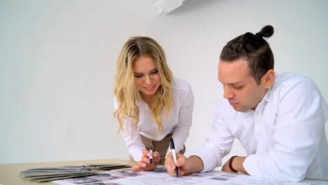 Close Up Of two Architects Discussing Plan Together At Desk With Blueprints Stock Footage 88642151