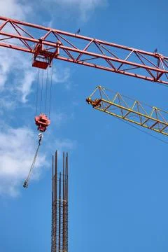 Close-up of two arrows of construction cranes arranged in parallel against a  Stock Photos