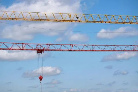 Close-up of two arrows of construction cranes arranged in parallel against a  Stock Photos