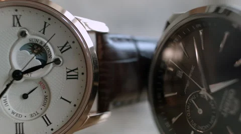 Close up of two black and white Wrist Watches with light background Vídeo Stock 68179515