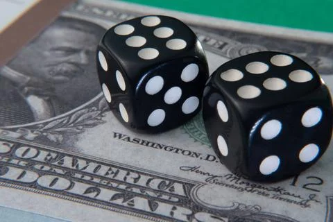 Close up two black dice on top showing the numbers six and six on an American Stock Photos