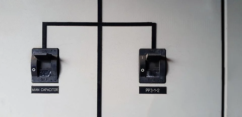 Close up Two black  electrical main breaker connect each other on gray Stock Photos