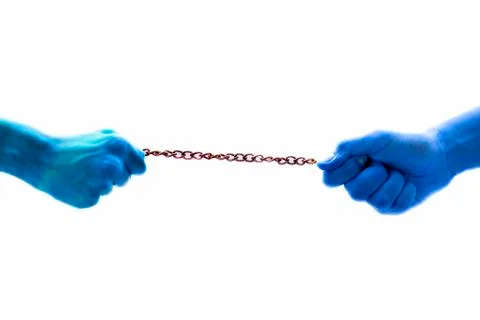 Close up of two blue colored hands isolated on white pulling a rusted chain,  Stock Photos
