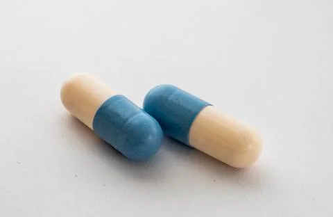 Close-up of two blue-white pill on white background Stock Photos