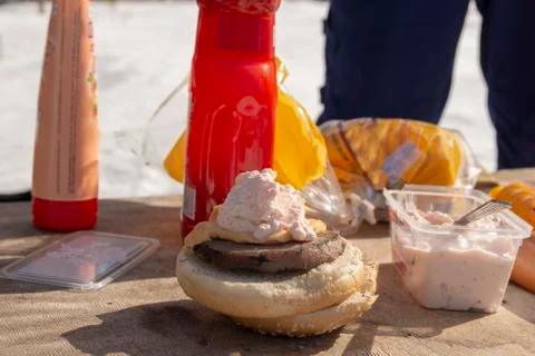 Close up of two bread on a table with a grilled sausage on and with lot of cr Stock Photos