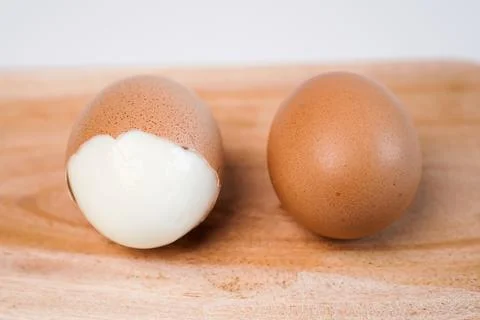 A close-up two brown chicken eggs placed horizontally side by side on a cle.. Stock Photos