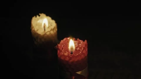 Close Up of Two Burning Beeswax Candles on a Black Background Stock-Footage 329839206