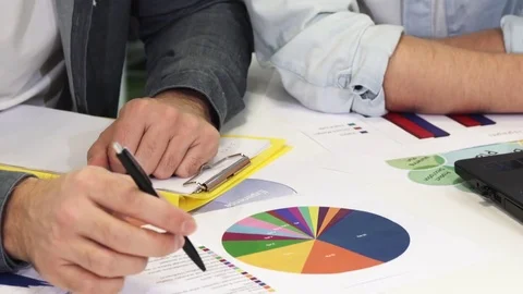Close up of two business colleagues talking examining documents Stock-Footage 85105207
