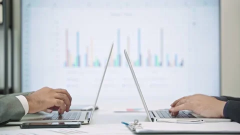 Close up two businessmen are working in the office. They uses a laptop for work. Stock Footage 149804835