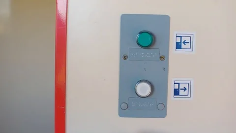 Close-up of two buttons. A child presses one button with his hand. Stock Footage 120515409