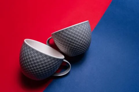 Close-up of two ceramic tea cups of grey and white colors.  Stock Photos