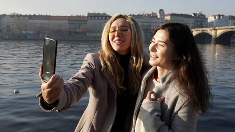 Close up of two cheerful stylish and friendly Caucasian and asian girls bloggers Stock Footage 135616878