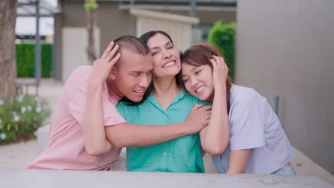 Close-up of two children hugging their mother with love and care. Looking at the Stock Footage 265143142