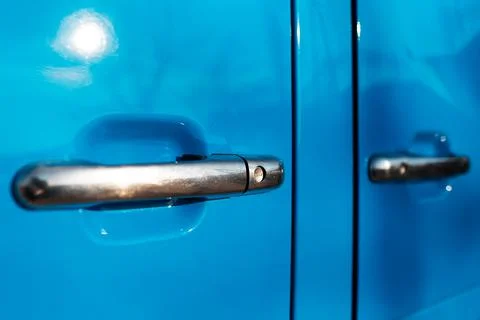 Close-up of two chrome door handle of blue car. Stock Photos