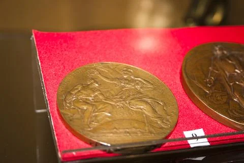 Close-up of two coins on a red sheet of paper. Stock Photos