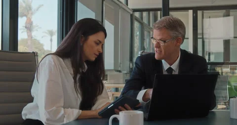 Close up of two colleagues discussing a new project using a computer. Stock Footage 139920519