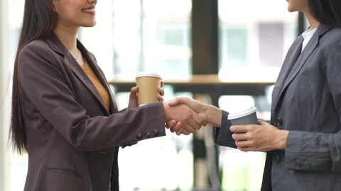Close-up of two colleagues shaking hands in office, symbolizing agreement, Stock Footage 280816275