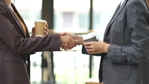 Close-up of two colleagues shaking hands in office, symbolizing agreement, Stock Footage 280816295
