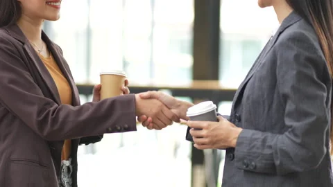 Close-up of two colleagues shaking hands in office, symbolizing agreement, Stock Footage 280816307