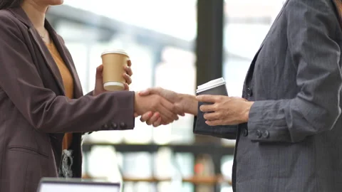 Close-up of two colleagues shaking hands in office, symbolizing agreement, Stock Footage 280816319