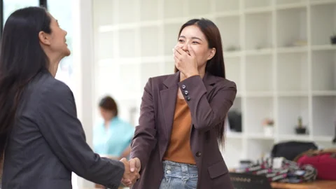 Close-up of two colleagues shaking hands in office, symbolizing agreement, Stock Footage 280816375