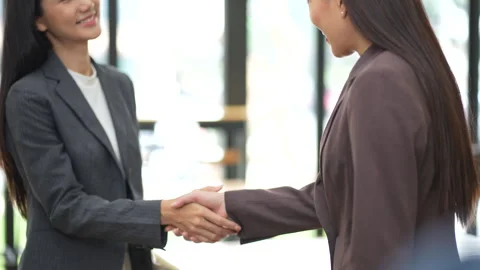 Close-up of two colleagues shaking hands in office, symbolizing agreement, Stock Footage 280816401