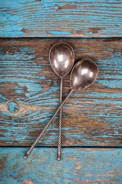 Close up of two copper tea spoons on old wooden board Free Stock Photos