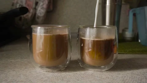 Close-up. Two cups of coffee with milk in the kitchen, glasses with a double Stock Footage 321643710