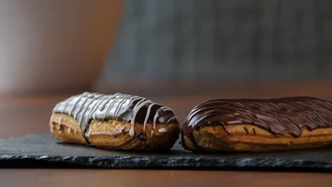 Close-up of two delicious chocolate eclairs 스톡 동영상 168188149