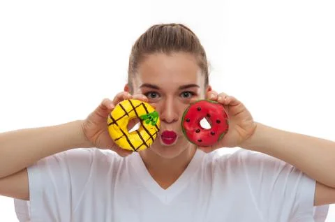 Close-up of two donuts in female hands Stock Photos