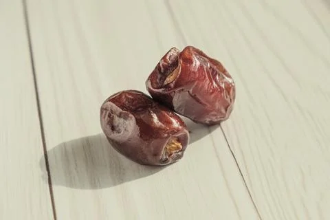 Close-up of two dried date palm fruit in the bright sun Stock Photos