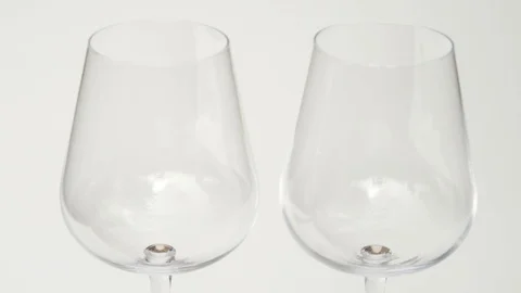 Close up of two empty wine glasses, red wine is poured into them Vidéo 115666712