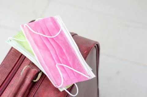 Close-up of two  face mask on a suitcase for travel or vacation   on honeymoo Stock Photos