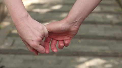 Close-up of two female hands holding each other 스톡 동영상 337774574