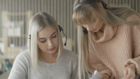 Close up of Two female office workers are checking documents in folder Stock Footage 108624481
