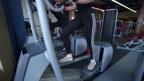 Close up of Two Female using Exercise Equipment in Gym 動画素材 122566975