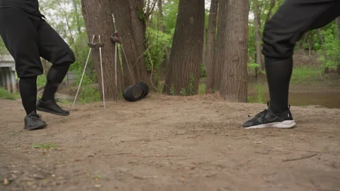 Close up of two fencers training sword fighting outdoors on dirt forest path Stock Footage 345082220