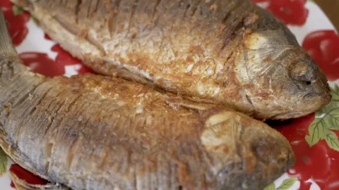 Close up, Two fish are frying in a pan Stock Footage 314218386