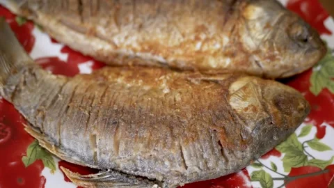 Close up, Two fish are frying in a pan Stock Footage 314218524