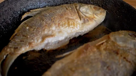 Close up, Two fish are frying in a pan Stock Footage 314218545