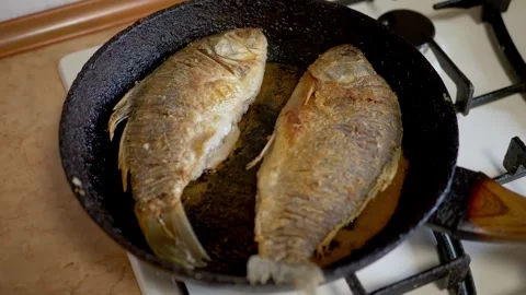 Close up, Two fish are frying in a pan Stock Footage 314218548