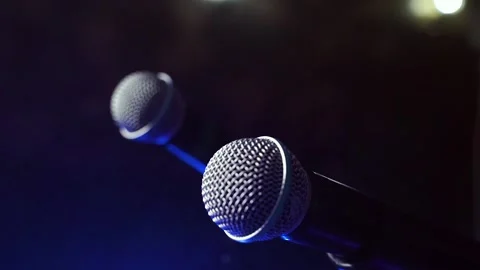 Close-up of two free microphones in a dark smoky room. Stock Footage 105898739
