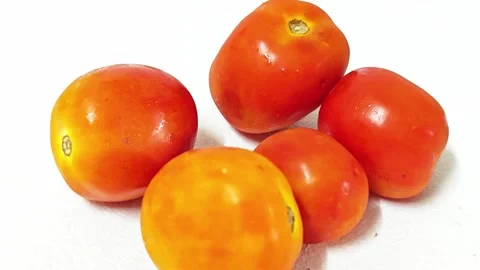 Close-up of two fresh ripe red tomatoes isolated on white Stockbeeldmateriaal 338991057