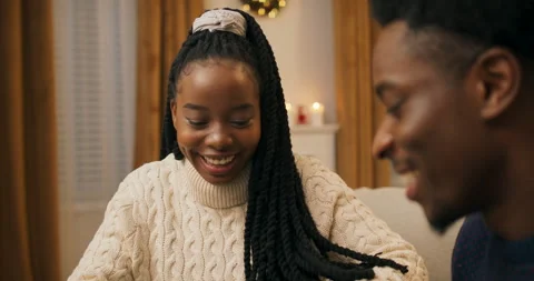 Close-up of two friends of African appearance exchanging gifts. The guy handed 스톡 동영상 211541018