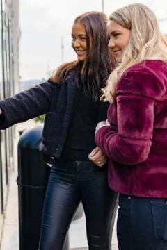 Close-up of Two Friends Doing Window Shopping In City Stock Photos